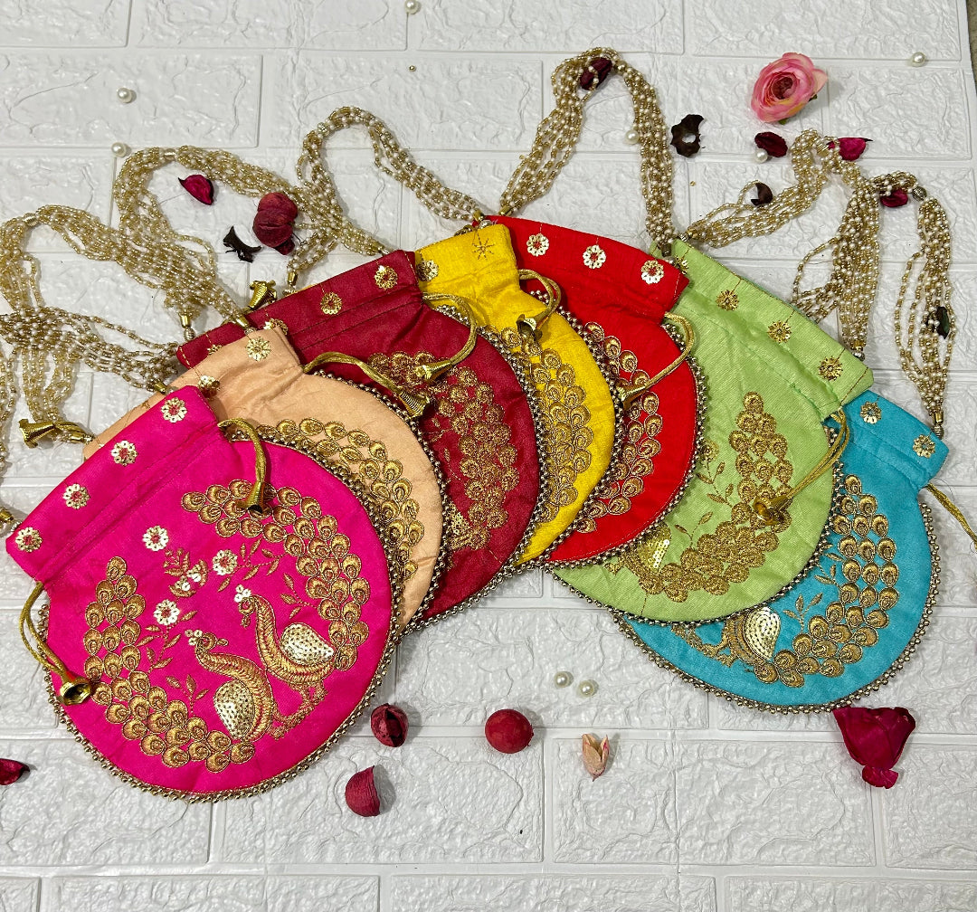 DesiTohfa colorful potli bags with intricate gold peacock embroidery and beaded handles in multiple colors