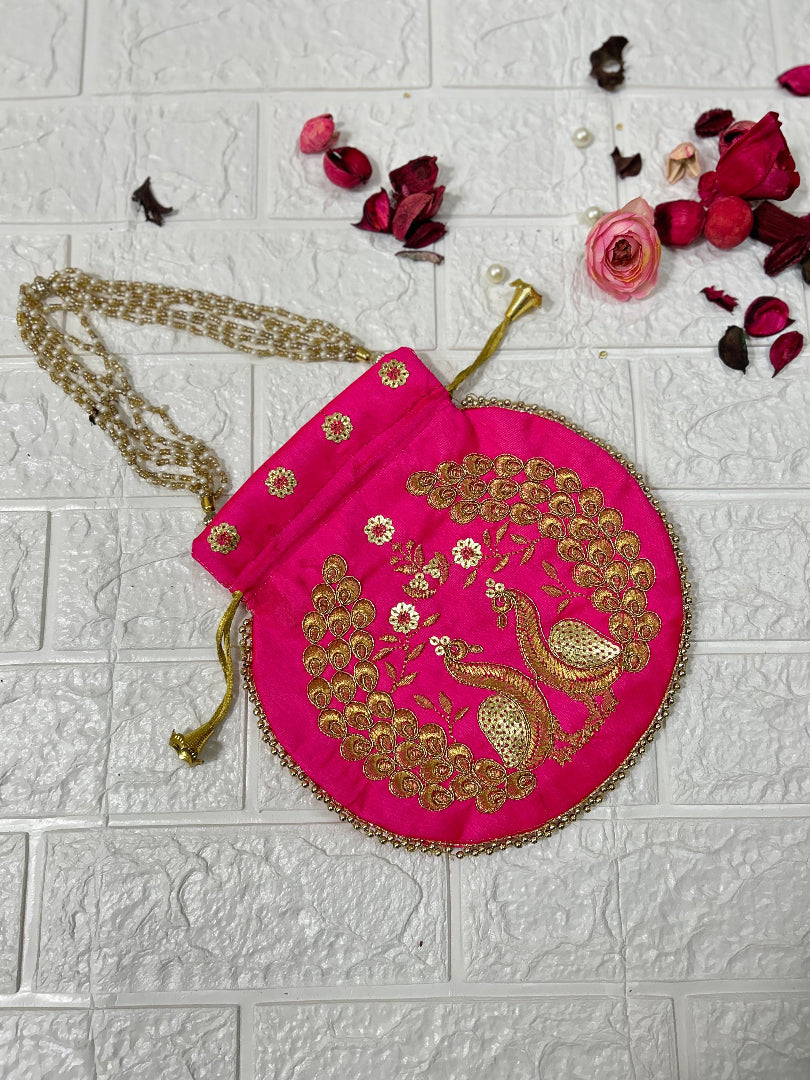 DesiTohfa pink potli bag with golden peacock embroidery and beaded drawstring closure