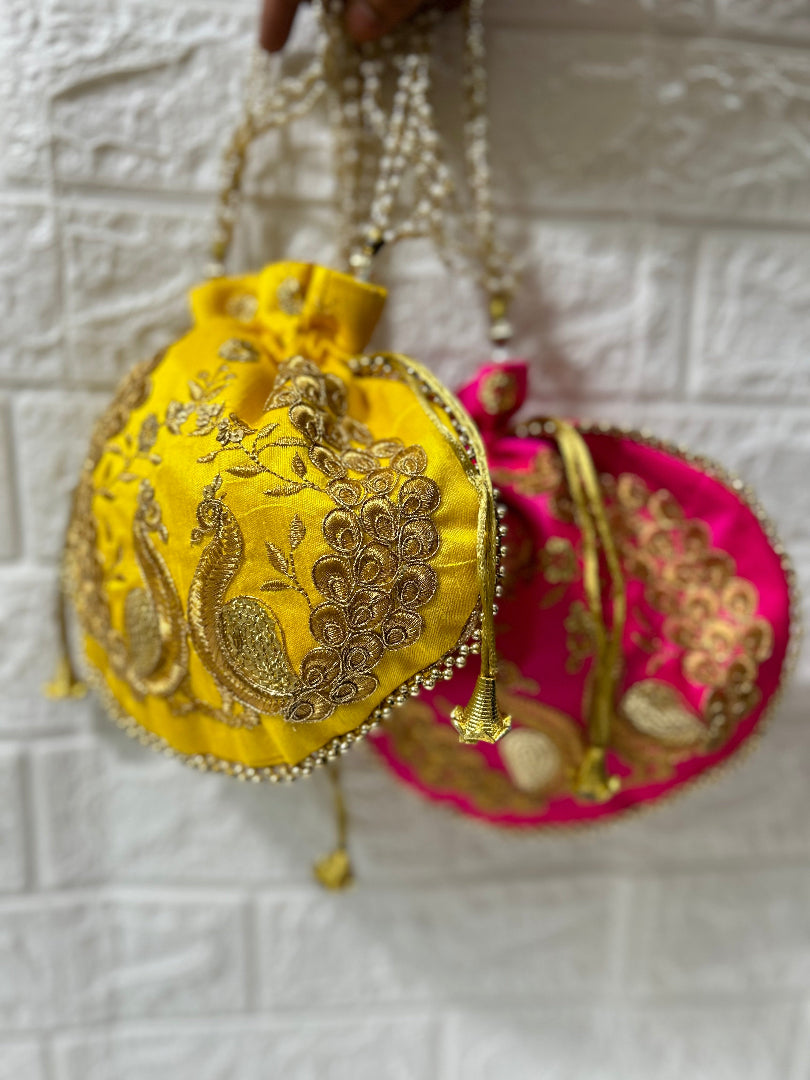 DesiTohfa embroidered potli bags in yellow and pink with gold thread work and drawstring closure