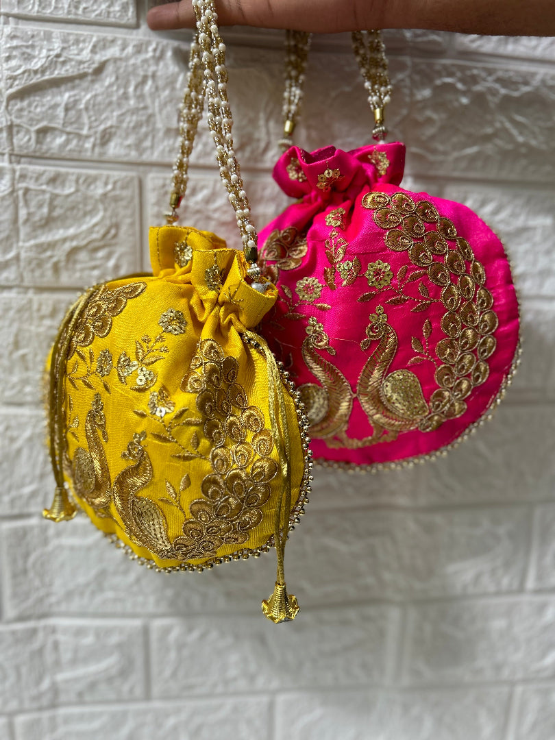 DesiTohfa potli bags in yellow and pink with gold peacock embroidery and beaded straps