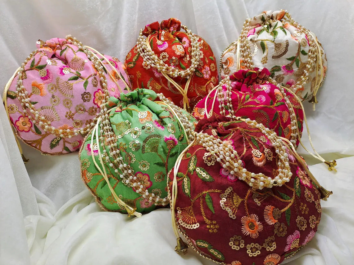 Desi Tohfa 50 Pieces Embroidered Potli Bags in assorted colors with floral designs and decorative strings