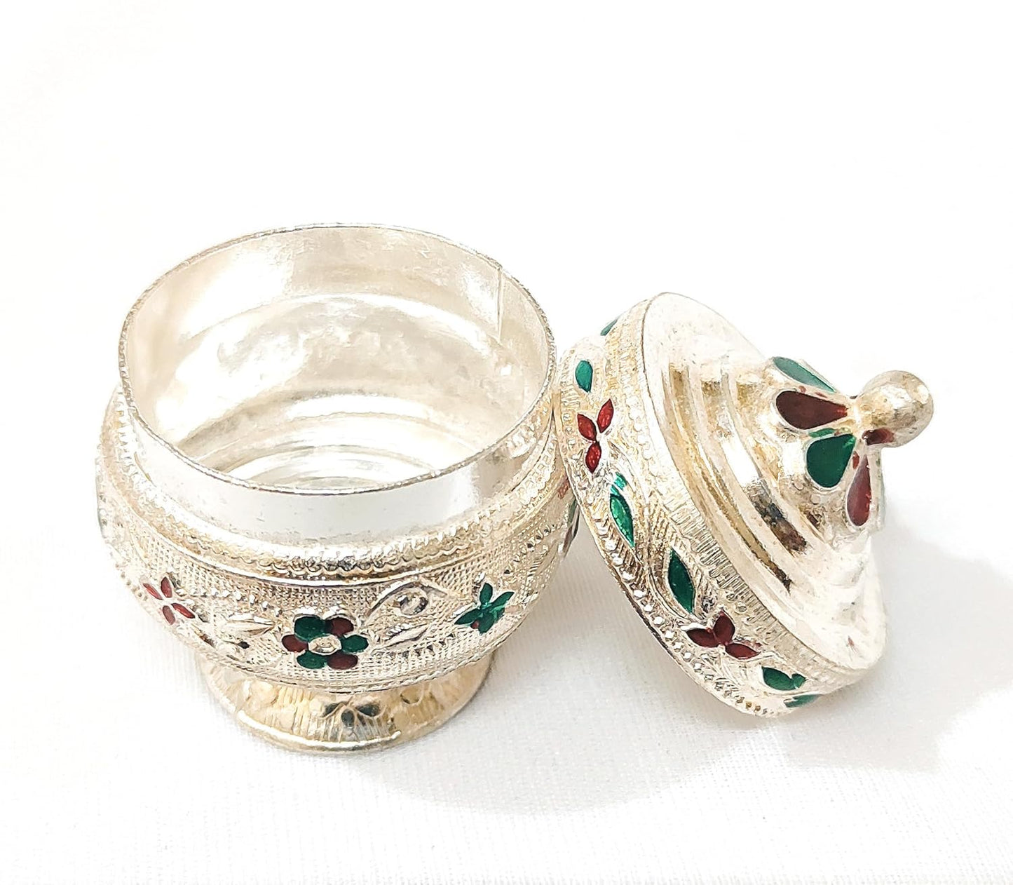 Decorative silver box with floral engravings on a white background