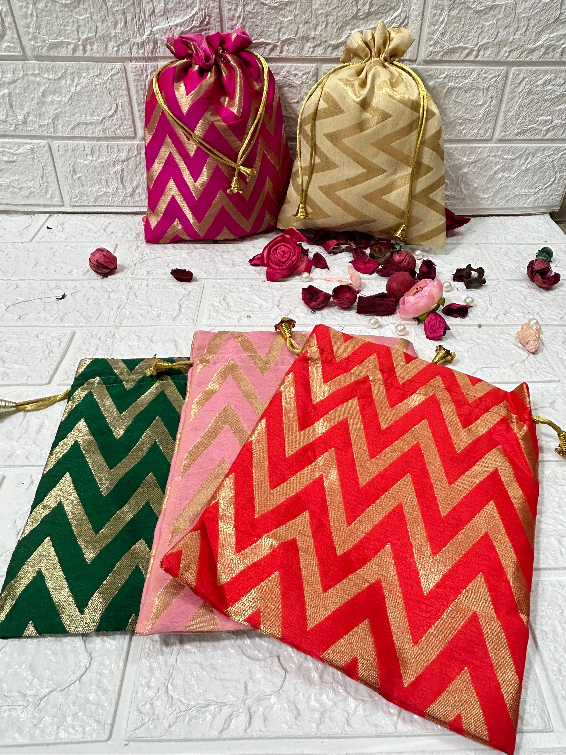DesiTohfa Brocade Potli Bags in red, pink, green, cream, and magenta with gold zigzag patterns
