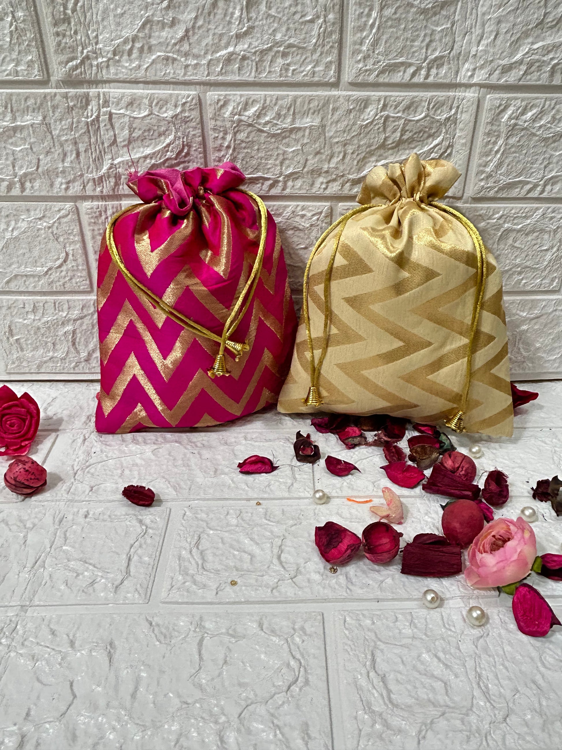 DesiTohfa Brocade Potli Bags in pink and gold with zigzag patterns and drawstring closures