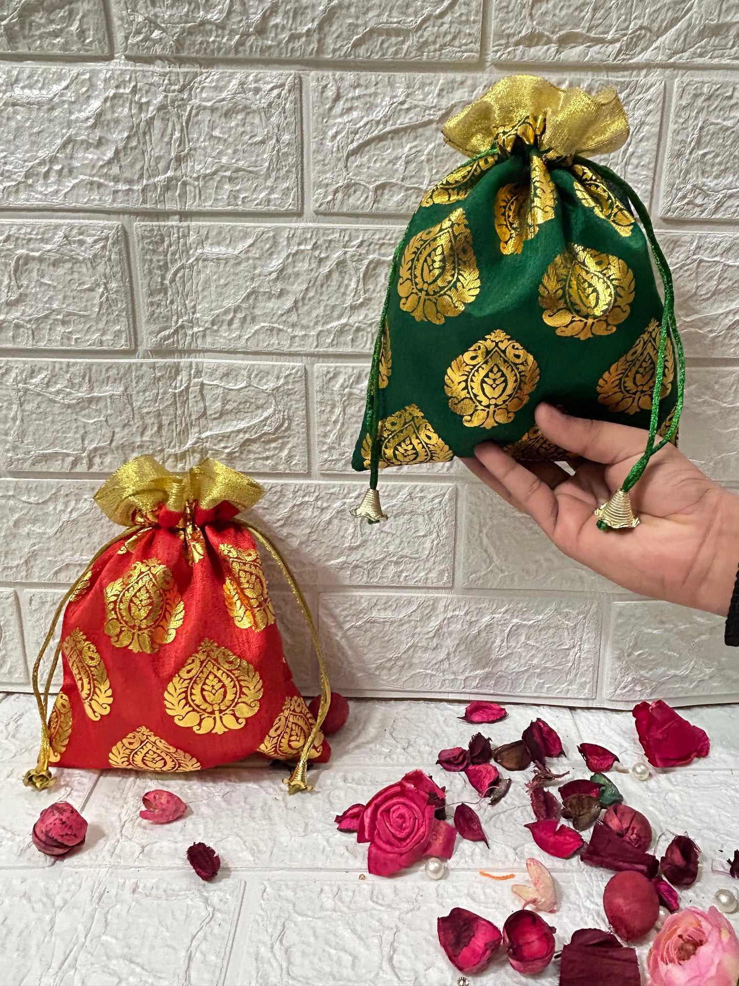 DesiTohfa gift packing potli bags in red and green with golden floral patterns and drawstring closure