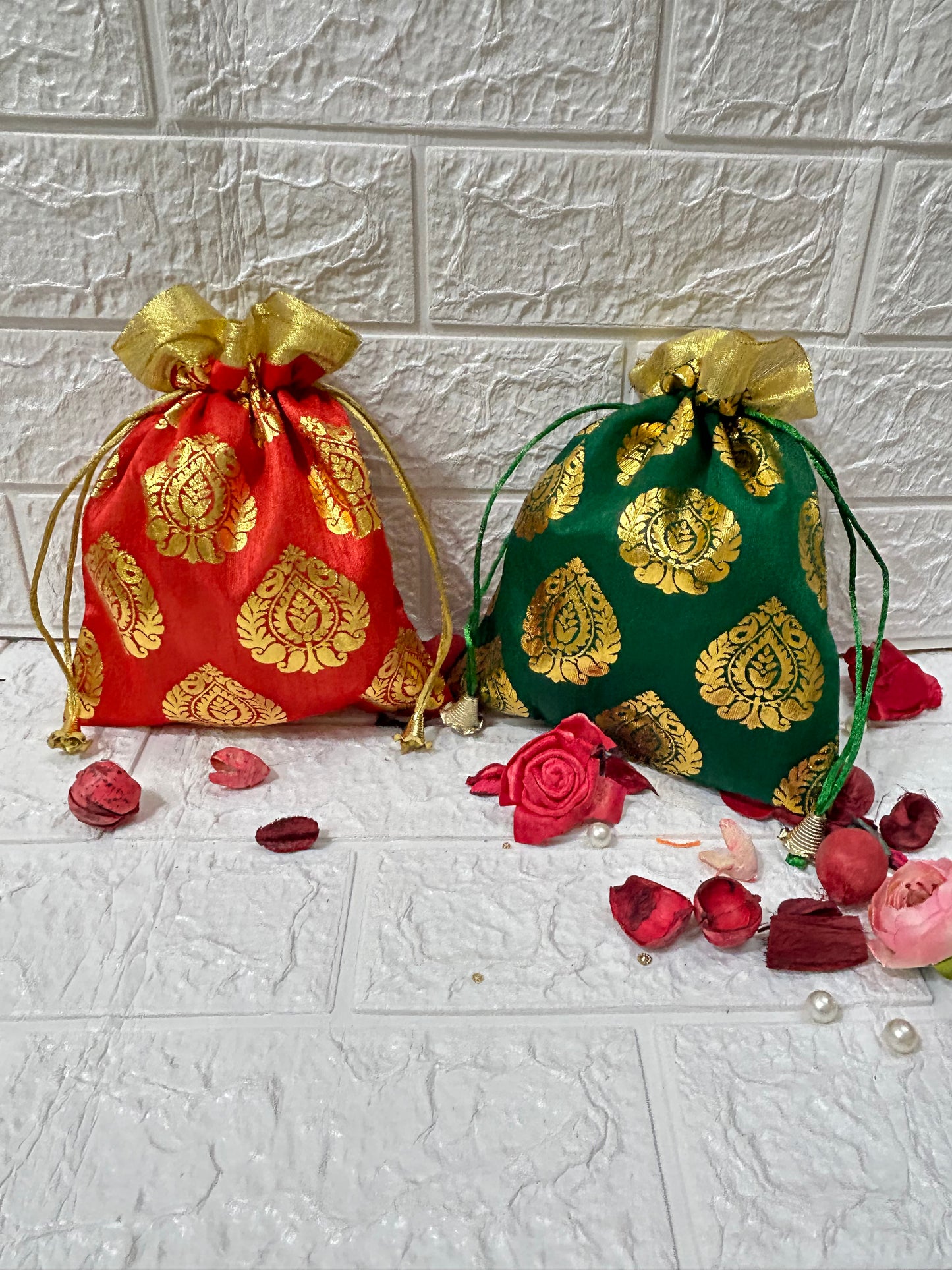DesiTohfa gift packing potli bags in red and green with gold floral patterns and drawstring closures