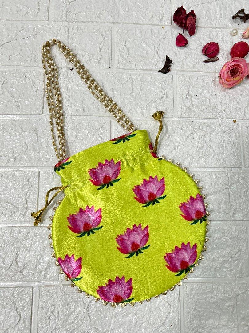 DesiTohfa vibrant yellow silk potli bags with pink lotus floral print and beaded handles
