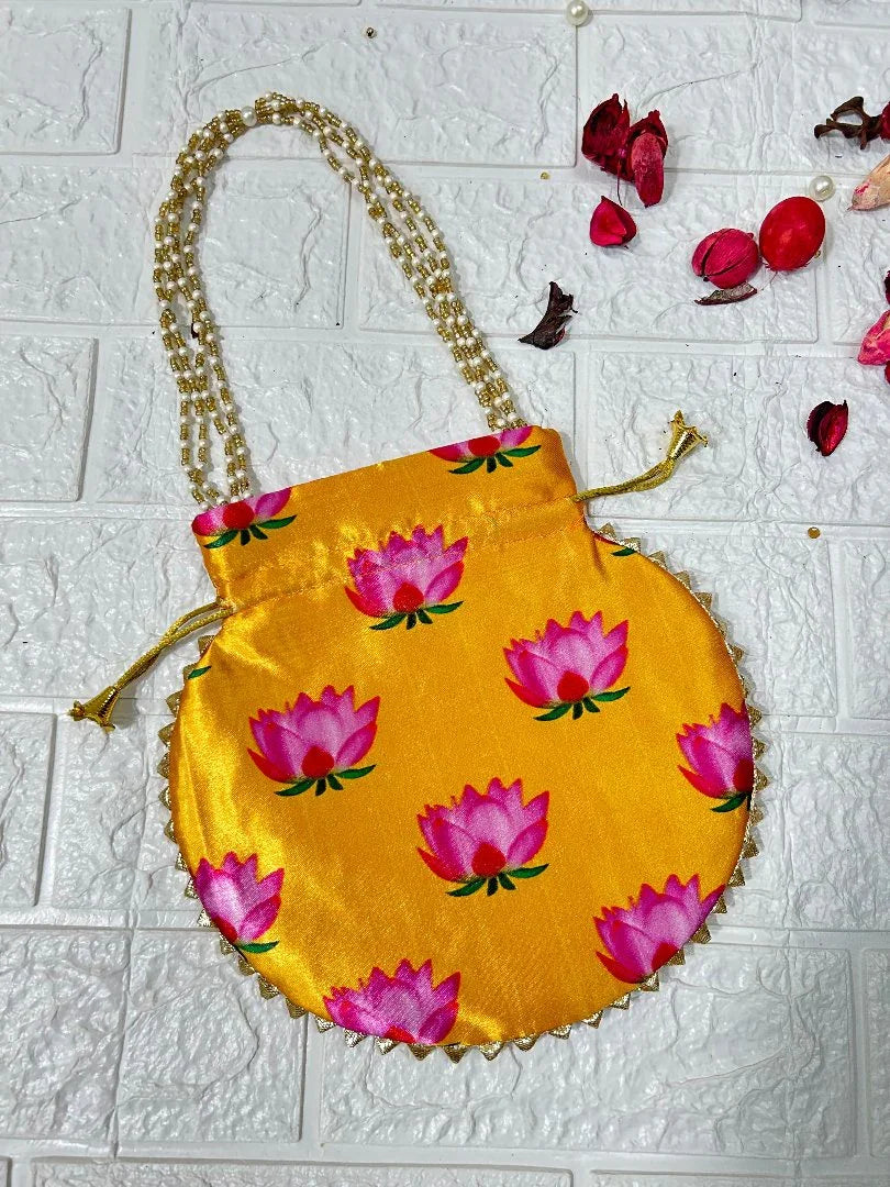 DesiTohfa yellow potli bag with pink lotus floral design and pearl handle for traditional use