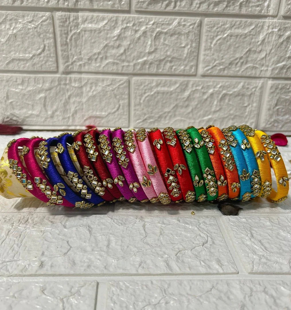 Colorful Silk Thread Bangles with gold embellishments arranged in a row by DesiTohfa