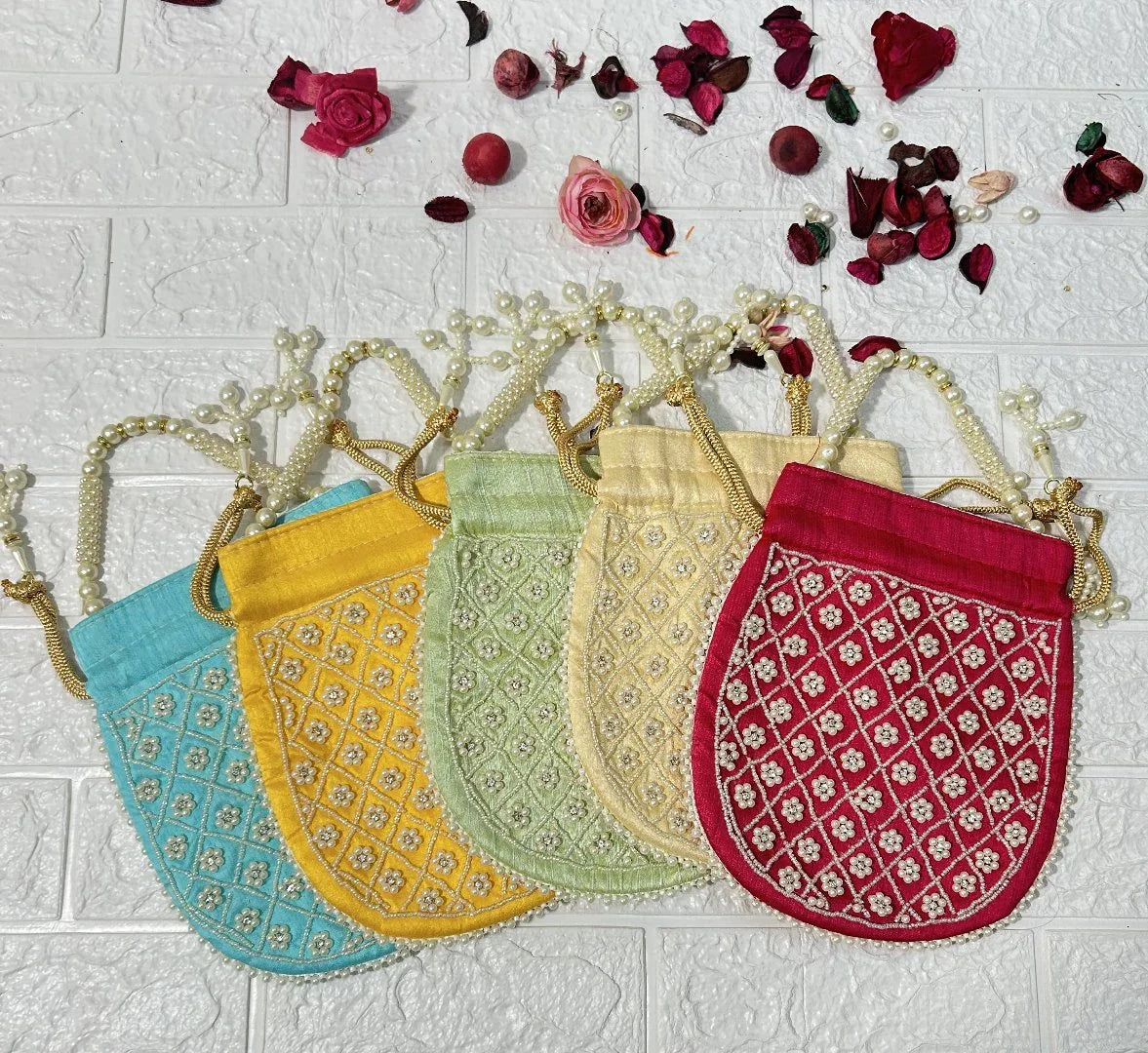 DesiTohfa Pearl Work Potli Bags For Bridesmaid Gifts in blue yellow green cream and red colors with decorative pearl handles