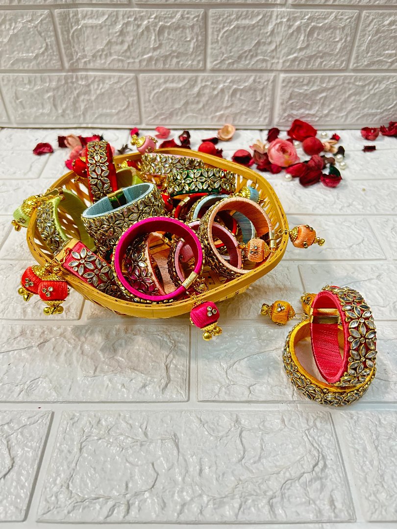 DesiTohfa Silk Thread openable Bangles in various colors with intricate gold designs displayed in a golden bowl