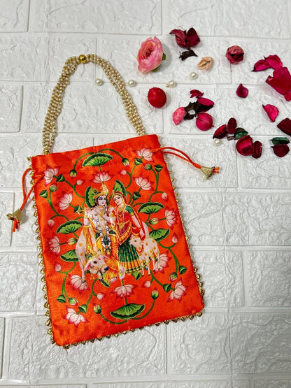 DesiTohfa orange potli bag with traditional Krishna Radha embroidery and pearl handle