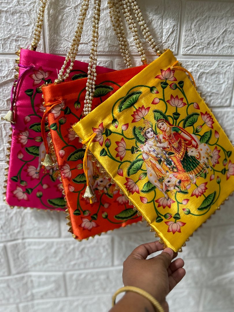 DesiTohfa colorful potli bags with traditional embroidery and bead handles in pink orange and yellow