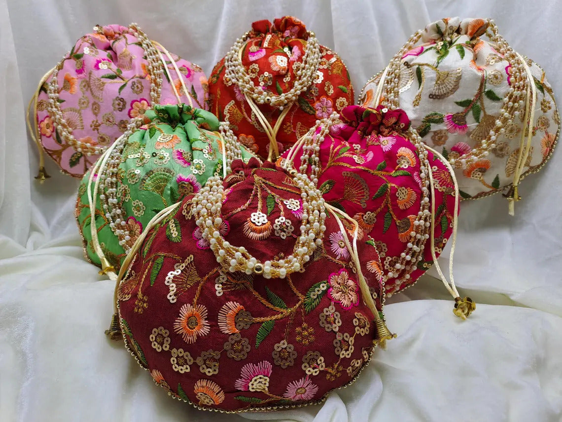 50 Pieces Embroidered Potli Bags in various vibrant colors with intricate floral designs and pearl embellishments