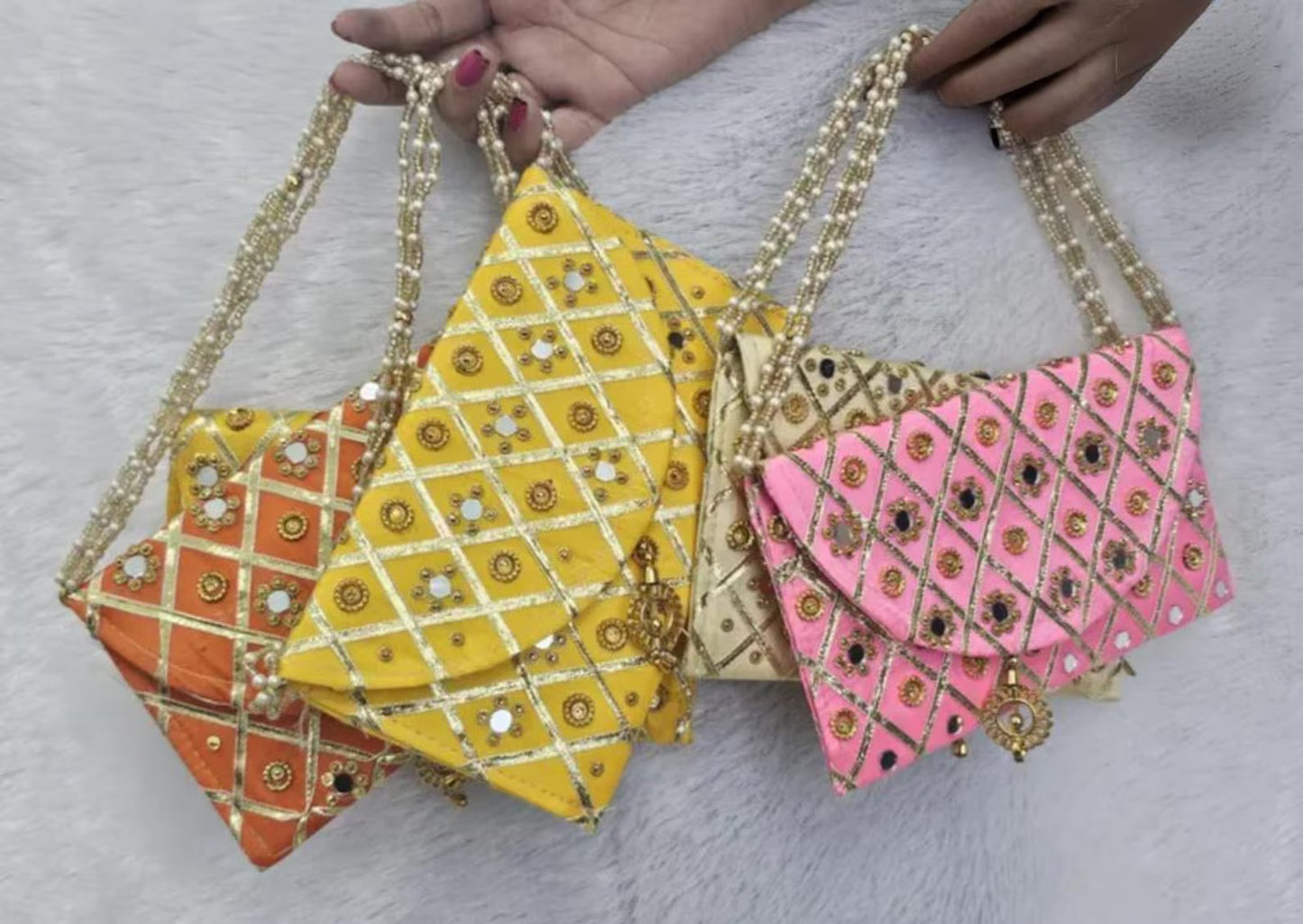 Add a vibrant ethnic touch to your celebrations with this Mirror Work Clutch, perfect for Mehendi & Sangeet return gifts. Stylish, handcrafted, and ideal for weddings, bridesmaid favors, and festive gifting.