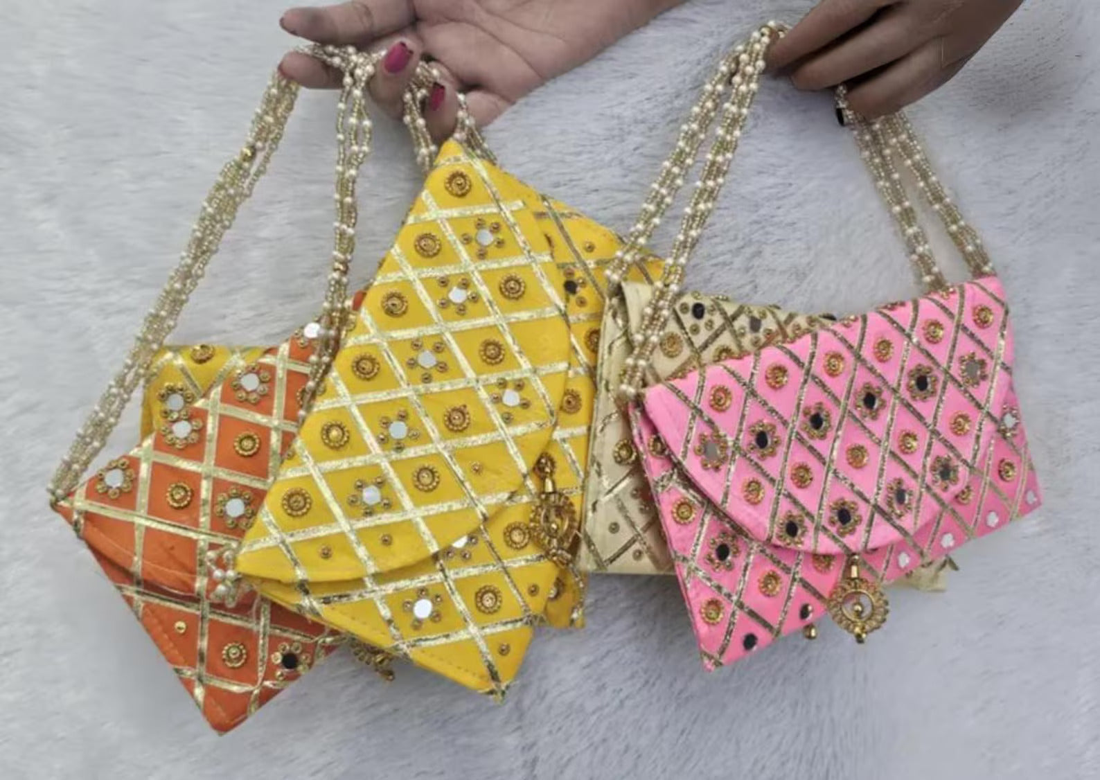 Add a vibrant ethnic touch to your celebrations with this Mirror Work Clutch, perfect for Mehendi & Sangeet return gifts. Stylish, handcrafted, and ideal for weddings, bridesmaid favors, and festive gifting.