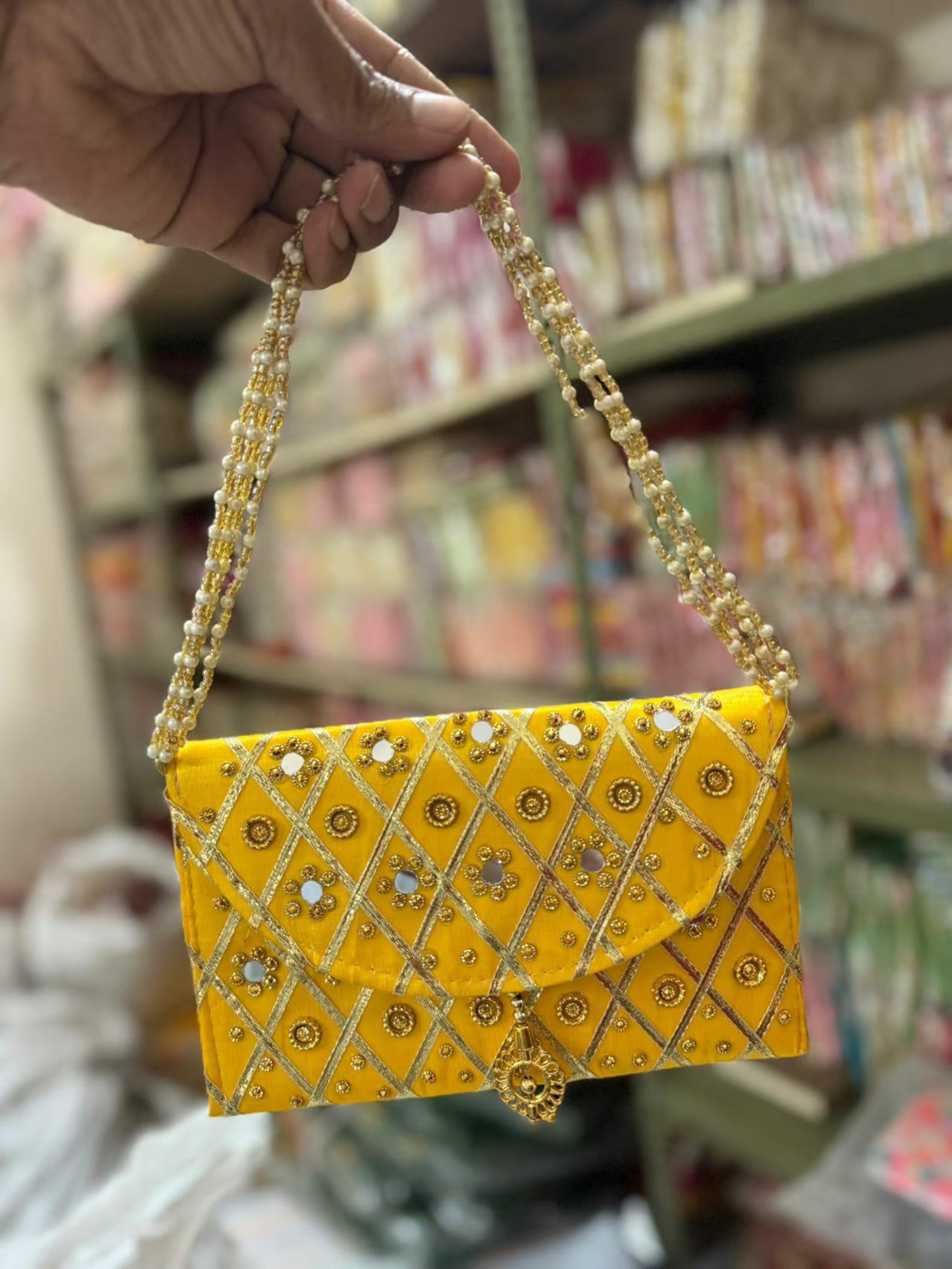 Add a vibrant ethnic touch to your celebrations with this Mirror Work Clutch, perfect for Mehendi & Sangeet return gifts. Stylish, handcrafted, and ideal for weddings, bridesmaid favors, and festive gifting.