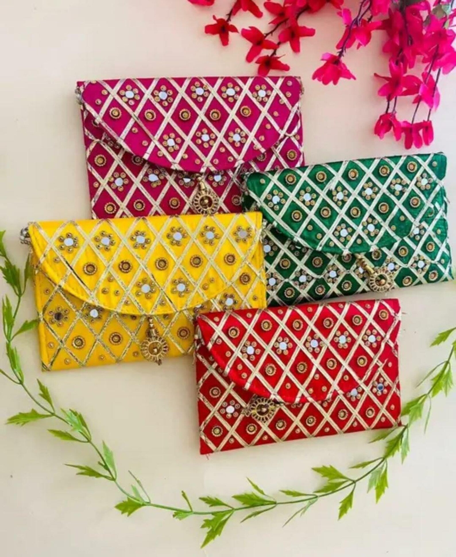 Add a vibrant ethnic touch to your celebrations with this Mirror Work Clutch, perfect for Mehendi & Sangeet return gifts. Stylish, handcrafted, and ideal for weddings, bridesmaid favors, and festive gifting.