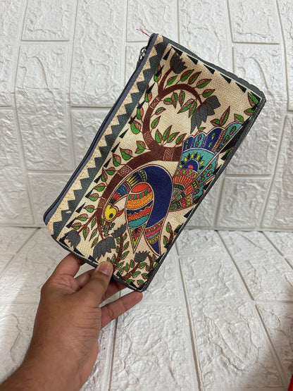 Handheld clutch with colorful tree design on a tiled floor background