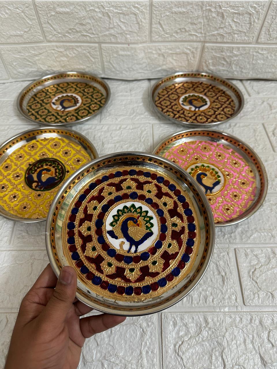 Decorative plates with intricate designs for return gifts.