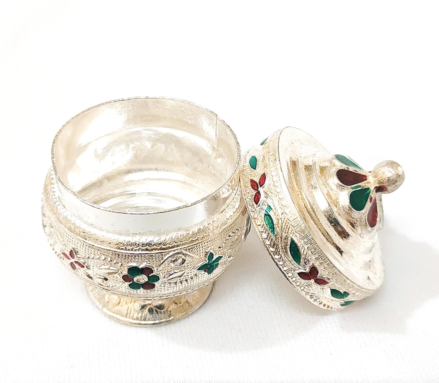 Decorative silver box with floral engravings on a white background