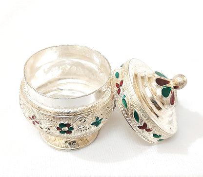 Decorative silver box with floral engravings on a white background
