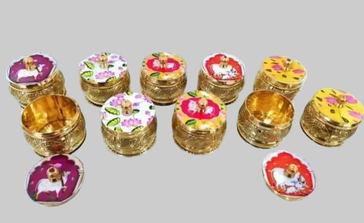 Set of small decorative items with floral designs on a white surface
