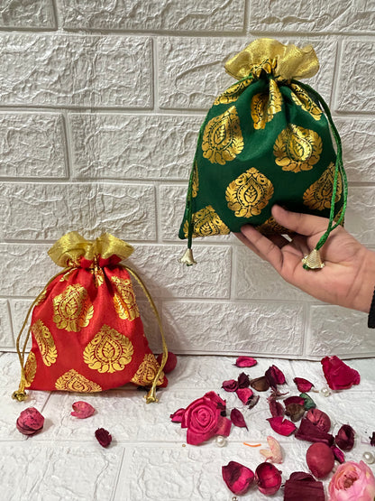 DesiTohfa gift packing potli bags in red and green with golden floral patterns and drawstring closure