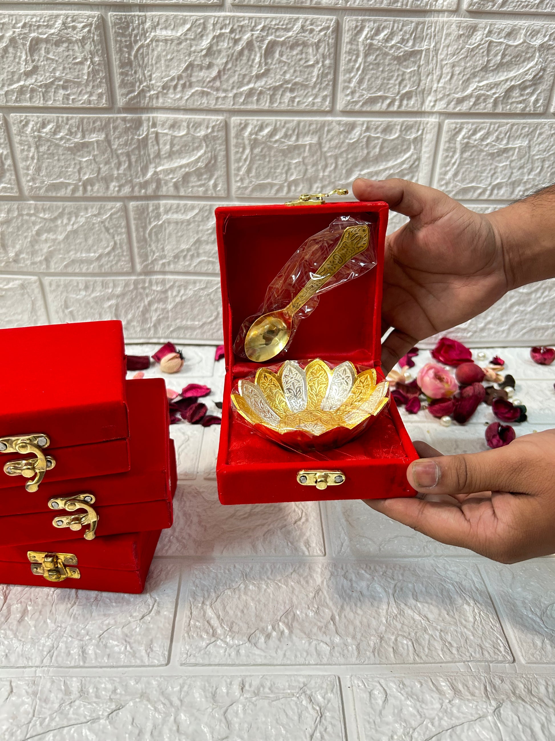 DesiTohfa gold-bowl-spoon-set in decorative red velvet box with intricate design held in hands