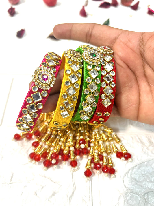 DesiTohfa Kundan Silk Thread Bangles in multicolor with golden bead tassels and intricate mirror work