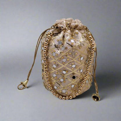 Desi Tohfa Mirror Work Round Potli bag in beige with gold and silver embellishments and drawstring closure