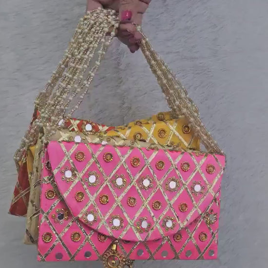 Add a vibrant ethnic touch to your celebrations with this Mirror Work Clutch, perfect for Mehendi & Sangeet return gifts. Stylish, handcrafted, and ideal for weddings, bridesmaid favors, and festive gifting.