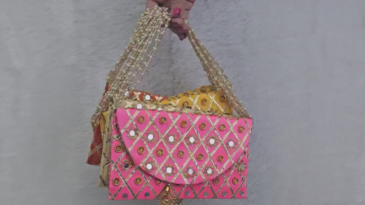 Add a vibrant ethnic touch to your celebrations with this Mirror Work Clutch, perfect for Mehendi & Sangeet return gifts. Stylish, handcrafted, and ideal for weddings, bridesmaid favors, and festive gifting.