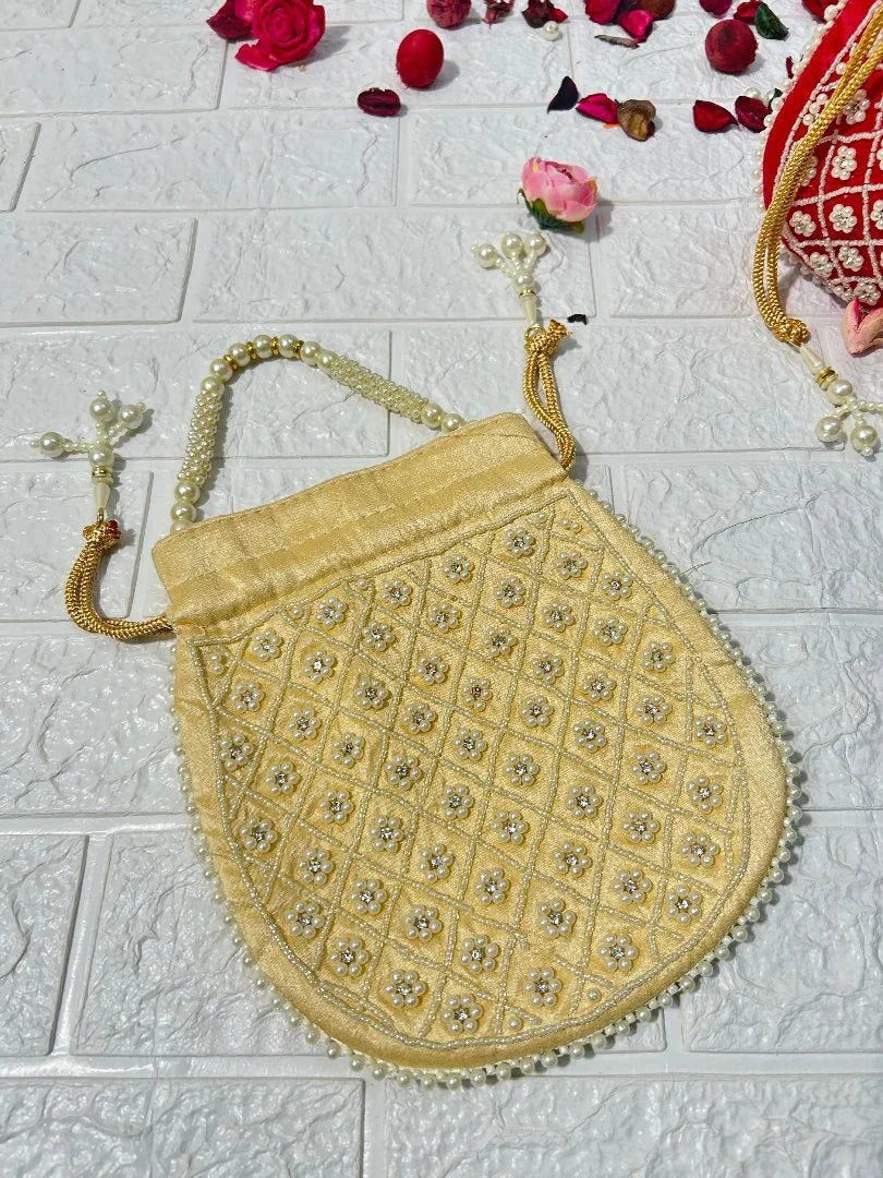Pearl Work Potli Bags For Bridesmaid Gifts in golden color with intricate bead and pearl detailing