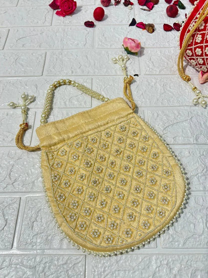 Pearl Work Potli Bags For Bridesmaid Gifts in golden color with intricate bead and pearl detailing