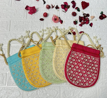 DesiTohfa Pearl Work Potli Bags For Bridesmaid Gifts in blue yellow green cream and red colors with decorative pearl handles