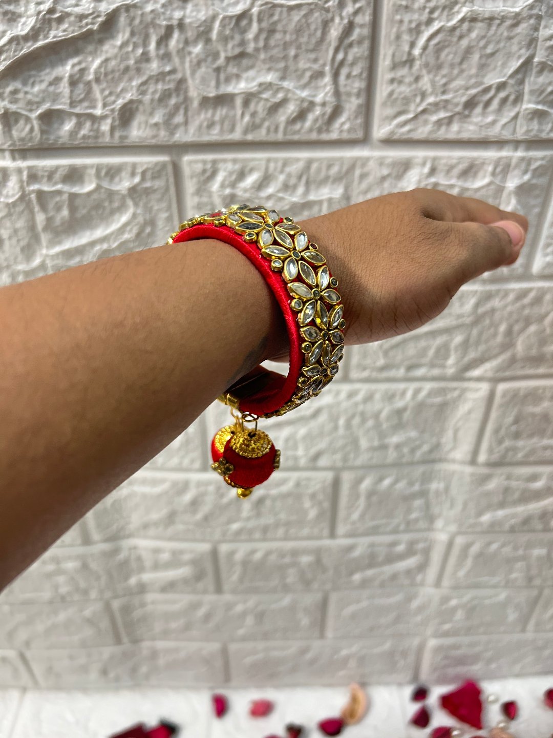 DesiTohfa Silk Thread openable Bangles in red with gold floral design worn on wrist