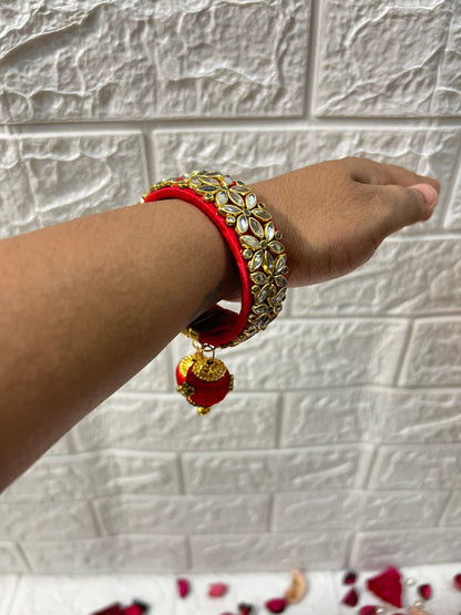 DesiTohfa Silk Thread openable Bangles in red with gold floral design worn on wrist